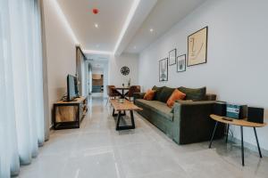 a living room with a couch and a table at Pearl Apartel in Volos