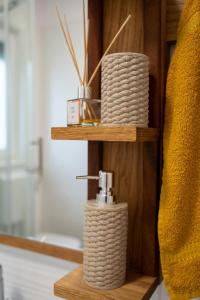 a wooden shelf with a roll of rope on it at House Family Podhum in Dražice