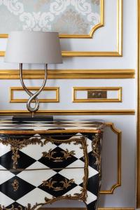 a lamp on top of a table in a room at Hotel Le Place d'Armes - Relais & Châteaux in Luxembourg
