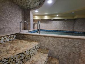 a large swimming pool in a building with a pool at Амстердам in Khmelnytskyi
