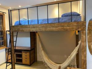 a bunk bed with a net in a room at Hostel 364 Santos Dorm Privativo com Alexa in Santos