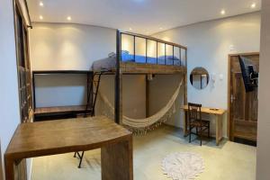 a room with two bunk beds and a desk at Hostel 364 Santos Dorm Privativo com Alexa in Santos
