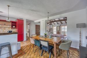 a kitchen and dining room with a wooden table and chairs at Vila Aryana With Pool - Happy Rentals in Sveti Lovreč Pazenatički