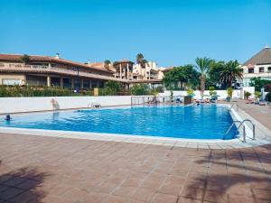 a large swimming pool in the middle of a building at On the Beach Holiday Home in Los Cristianos