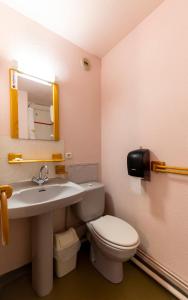 uma casa de banho com um WC, um lavatório e um espelho. em HOTEL DES NEIGES em Les Deux Alpes