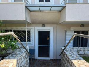 a house with a staircase leading to a door at CELENA CITY in Kalamata