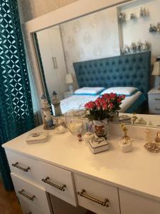 a bedroom with a bed and a dresser with a mirror at Eliz Garden in Kutaisi
