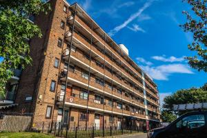 a large brick building on a street at Comfortable Room-Only Room in London