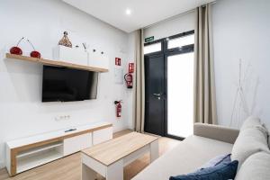 a living room with a couch and a tv at Apartamento acogedor y cómodo GUAD-C in Madrid