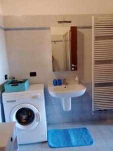 a bathroom with a washing machine and a sink at CASA NICCA in Oleggio +11 photos