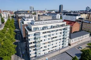 an aerial view of a large white building in a city at 2ndhomes Tampere "Koskenranta" Apartment - Sauna, Rooftop Terrace, Amazing Views & Free Parking in Tampere