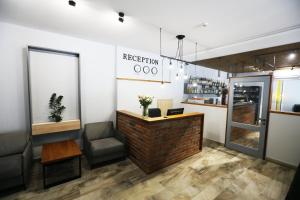 a restaurant with a reception desk and a chair at Hotel Golden lemon Готель Золотий лимон in Lviv