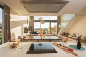a kitchen with a table and a living room at Villa Maris - Luxury Villa with Pool in Brodarica