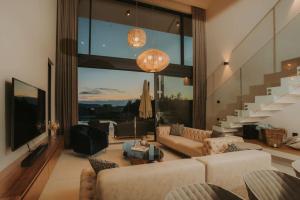 a living room with couches and a large window at Villa Maris - Luxury Villa with Pool in Brodarica