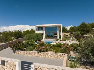 a house with a swimming pool and a garden at Villa Maris - Luxury Villa with Pool in Brodarica