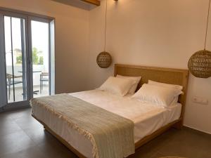A bed or beds in a room at Sohoros Luxury Suites