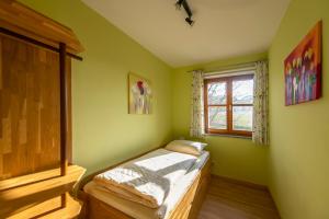 a small bedroom with a bed and a window at Scheidlerhof in Theisseil