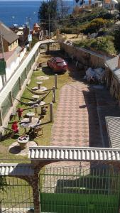 a car is parked in a yard next to the ocean at Hotel Utama in Copacabana