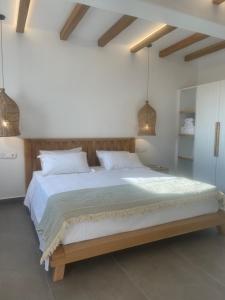 A bed or beds in a room at Sohoros Luxury Suites