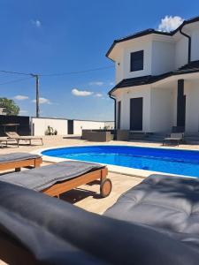 a swimming pool in front of a house at Villa Diamond in Bijeljina