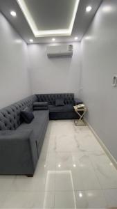 a living room with a couch in a room at Manazel Al Faisal Furnished Apartments in Al Baha