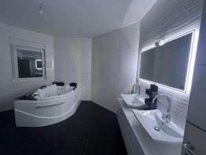 a white bathroom with a tub and a sink at Villa Diamond in Bijeljina +15 photos
