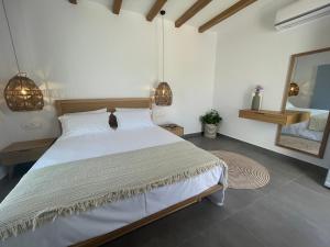 A bed or beds in a room at Sohoros Luxury Suites