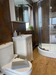 a bathroom with a shower and a toilet and a sink at Alexander Apartments South Shields 3 in South Shields