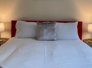 a white bed with two pillows and two lamps at Alexander Apartments South Shields 3 in South Shields