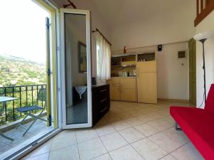 a living room with a sliding glass door to a balcony at Afroessa apartments in Mesariá