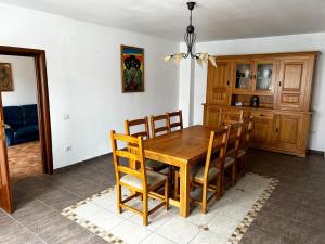 a kitchen and dining room with a wooden table and chairs at Spacious, 3BD home in Radauti in Rădăuţi