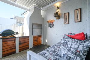 a bedroom with a bed in a room with a window at The Halfway House @ Kingswood Golf Estate in George