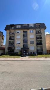 un gran edificio de apartamentos en el lateral de una calle en Harmony apartman, en Donji Milanovac