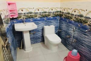 a bathroom with a toilet and a sink at OYO Riverview Resort And Restaurant in Jhājhar
