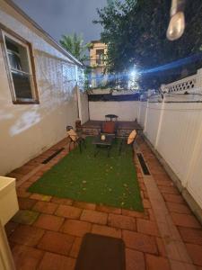 a small patio with a table and chairs on a balcony at Cosy Modern Home Mins to NYC! in Union City