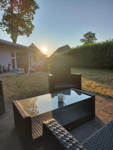 a patio with a coffee table and a couch at Limburg-Chalet in Susteren
