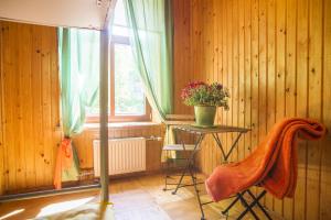 a room with a table and a chair and a window at Green Jurmala Hostel in Jūrmala
