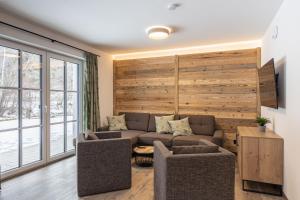 a living room with a couch and chairs at AlpiNest Feriendorf Lungau in Mariapfarr