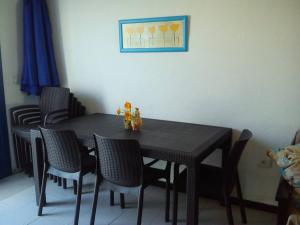 a black dining room table with chairs and a painting at Casa Leyna in El Golfo