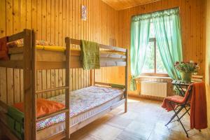 a bedroom with two bunk beds and a window at Green Jurmala Hostel in Jūrmala