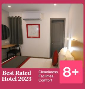 a hotel room with a bed and a sign that reads best rated hotel destinations at Hotel IP Residency Anand Vihar in New Delhi