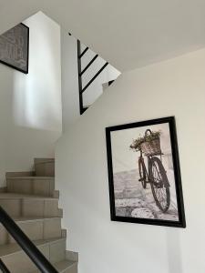 a framed picture of a bike hanging on a wall at Villa Gaïa - 2 suites lits King size et salles de bain privatives - parking privé - 10 minutes Eurexpo - Aéroport - Groupama Stadium in Genas