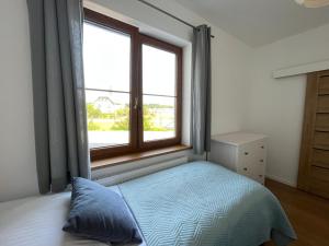 Łóżko lub łóżka w pokoju w obiekcie Apartament z ogrodem