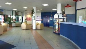 a lobby of a store with chairs and a counter at VVF Urrugne Saint-Jean-de-Luz Côte Basque in Urrugne