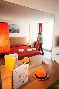 a boy is standing in a hotel room at VVF Urrugne Saint-Jean-de-Luz Côte Basque in Urrugne