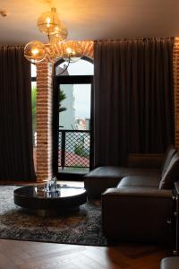 a living room with a couch and a coffee table at Mandarin Club House in Batumi