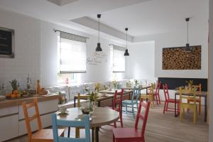 a restaurant with tables and chairs in a room at Villa Millennium in Balatonalmádi