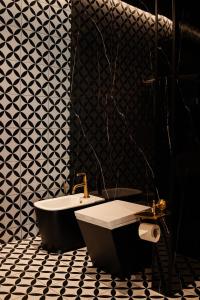 a bathroom with a bath tub and a toilet at Mandarin Club House in Batumi