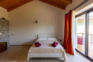 a bedroom with a bed with purple pillows on it at Agriturismo Casa del Principe in Torre Bormida