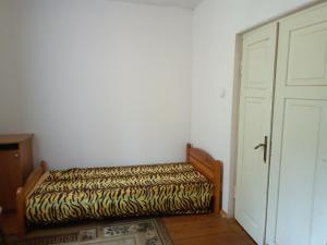 a bed sitting in a room next to a door at Leśniczówka Turowo - Podlasie 